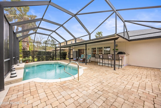 view of pool featuring a patio area, a lanai, and a fenced in pool