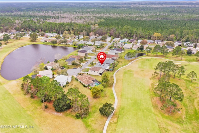 drone / aerial view with a forest view, a water view, and a residential view