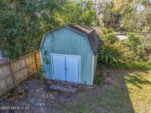 view of shed featuring fence