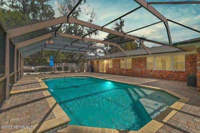 pool featuring a lanai and a patio area