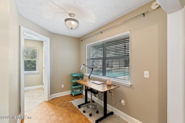 office featuring a textured ceiling and baseboards