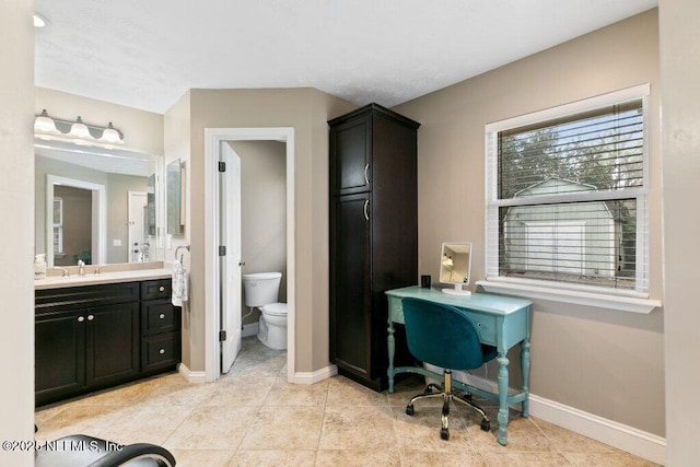 bathroom featuring tile patterned floors, vanity, toilet, and baseboards