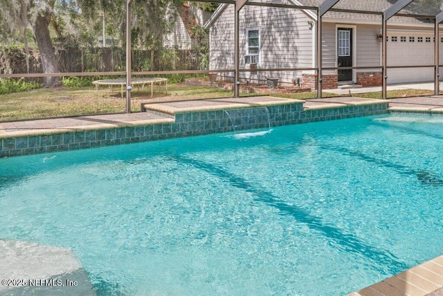 pool with glass enclosure and a patio