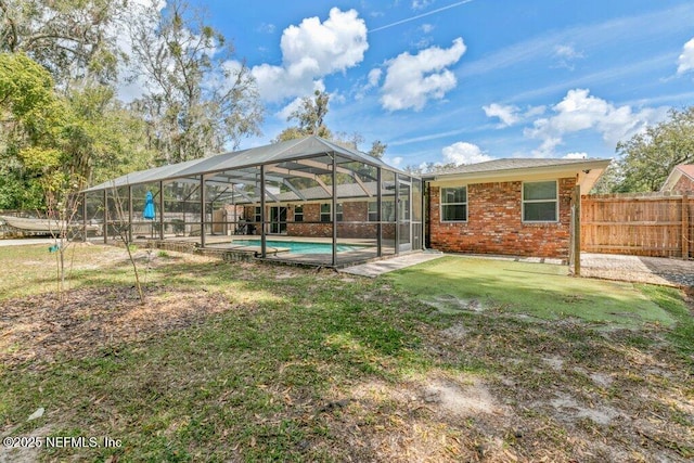 exterior space with glass enclosure, fence, and a fenced in pool