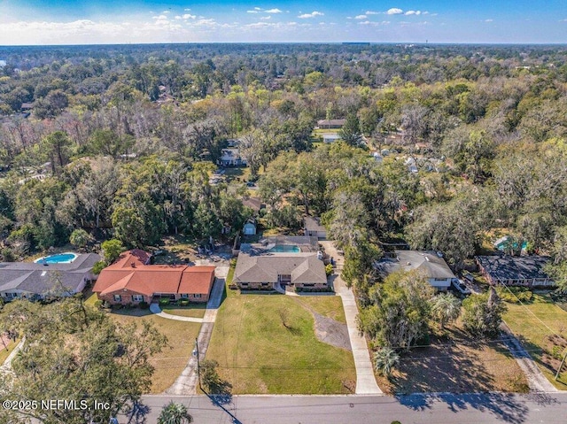 birds eye view of property with a wooded view