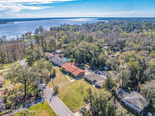 drone / aerial view featuring a water view and a forest view