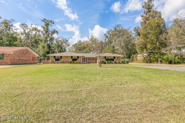 ranch-style home featuring a front yard and brick siding