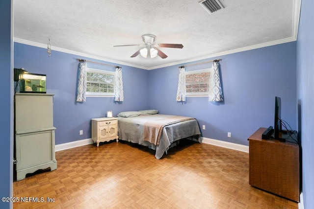 bedroom featuring baseboards, visible vents, and a textured ceiling