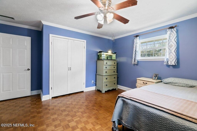 bedroom with a textured ceiling, crown molding, visible vents, and baseboards