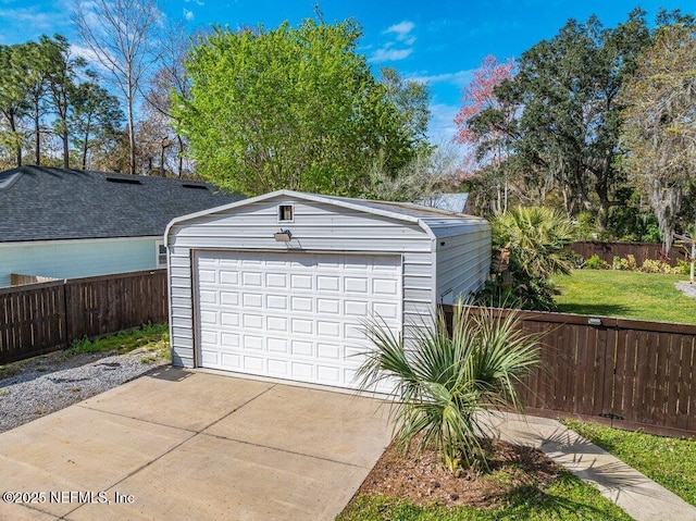 detached garage featuring fence