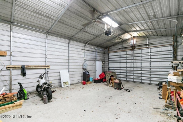 garage with metal wall and a garage door opener