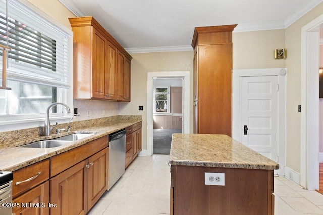 kitchen with a sink, crown molding, a kitchen island, and dishwasher