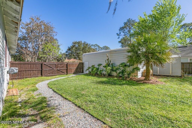 view of yard featuring an outdoor structure and fence