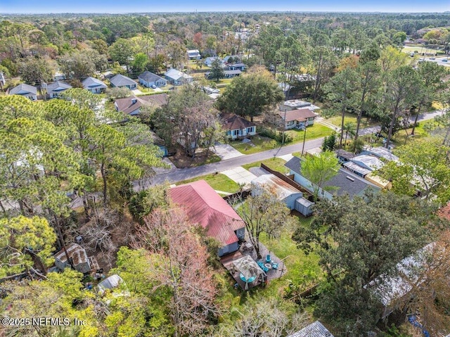 bird's eye view with a wooded view and a residential view