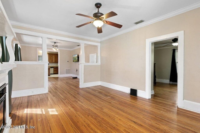 unfurnished living room with light wood finished floors, a fireplace, and visible vents