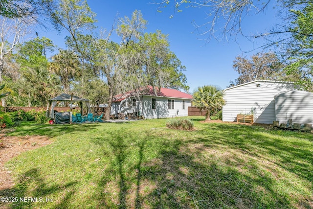 view of yard featuring a gazebo and fence