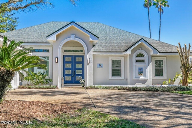 single story home with stucco siding and a shingled roof