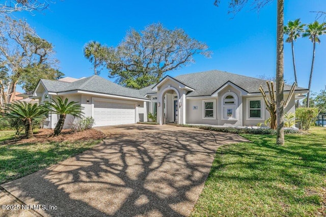 ranch-style home featuring stucco siding, a front lawn, concrete driveway, an attached garage, and a shingled roof