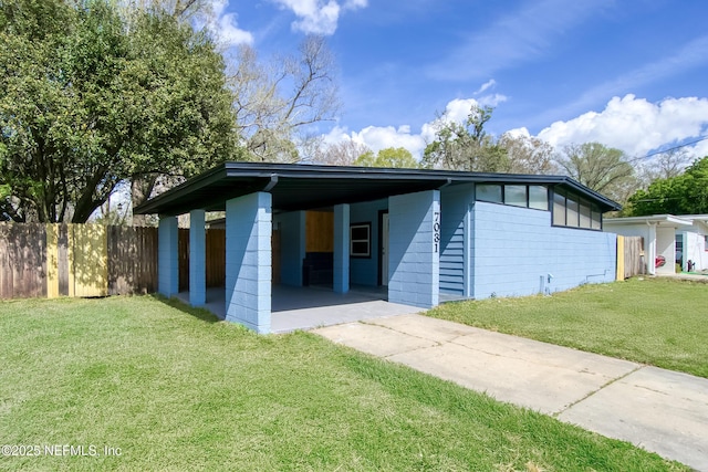 mid-century inspired home featuring fence, a front lawn, and an attached carport