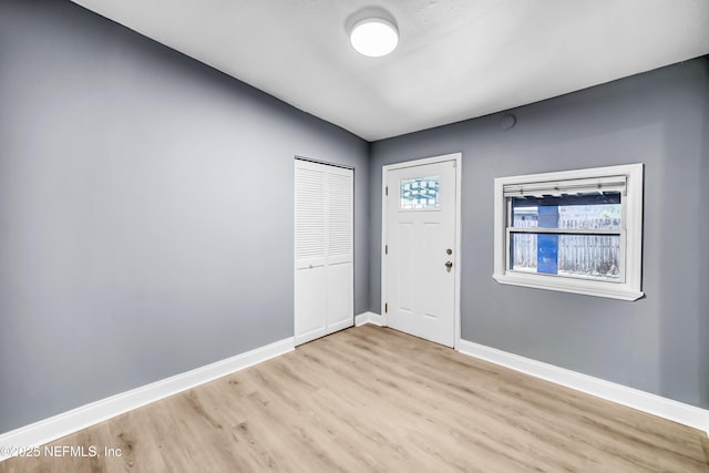 entrance foyer with light wood-style flooring and baseboards