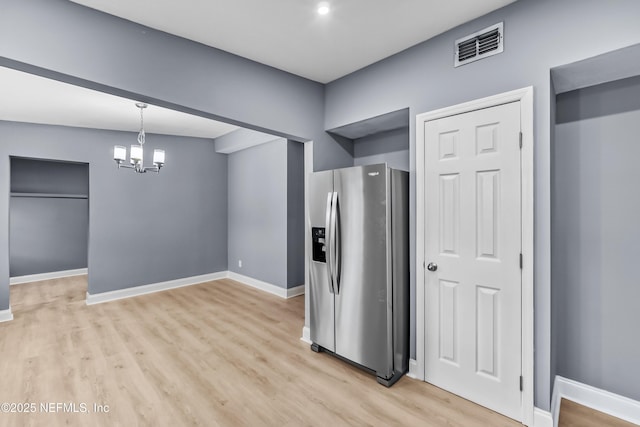 kitchen featuring baseboards, visible vents, stainless steel fridge with ice dispenser, an inviting chandelier, and light wood-style floors