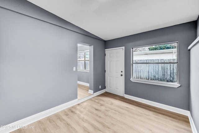 empty room featuring wood finished floors and baseboards