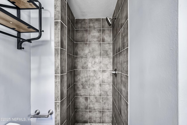 bathroom with a tile shower