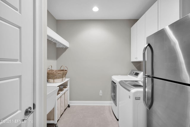 washroom featuring washer and clothes dryer, recessed lighting, cabinet space, and baseboards