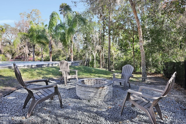 view of patio featuring a fire pit and fence