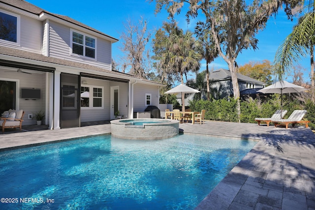 view of swimming pool with a patio area and a pool with connected hot tub