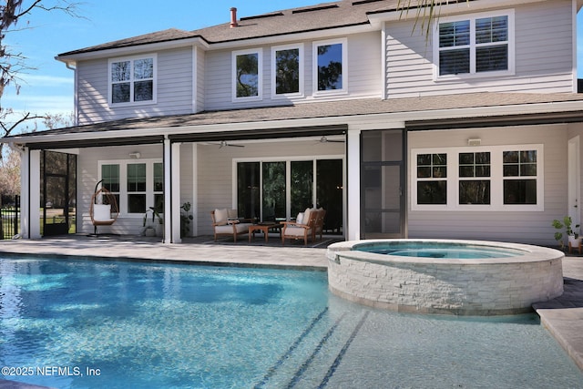 back of property featuring an outdoor pool, a patio, an in ground hot tub, and a ceiling fan