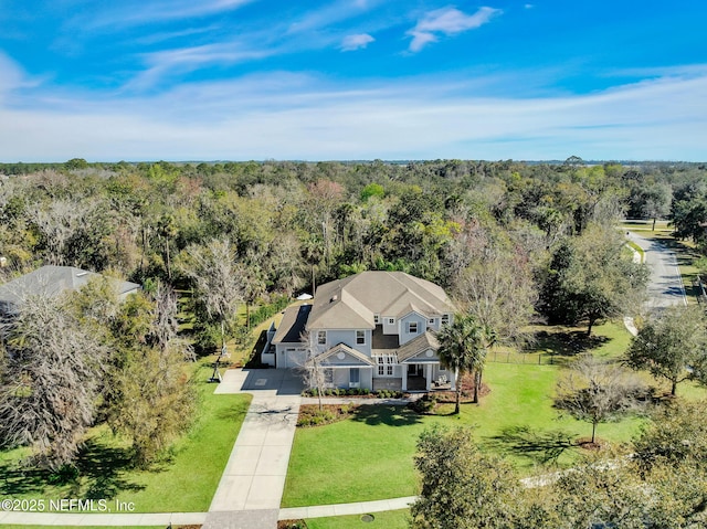 bird's eye view featuring a wooded view