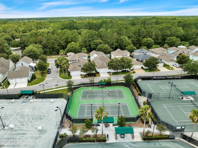 drone / aerial view featuring a residential view and a forest view