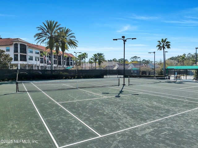 view of tennis court with fence