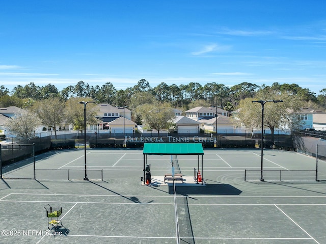 view of sport court featuring a residential view and fence