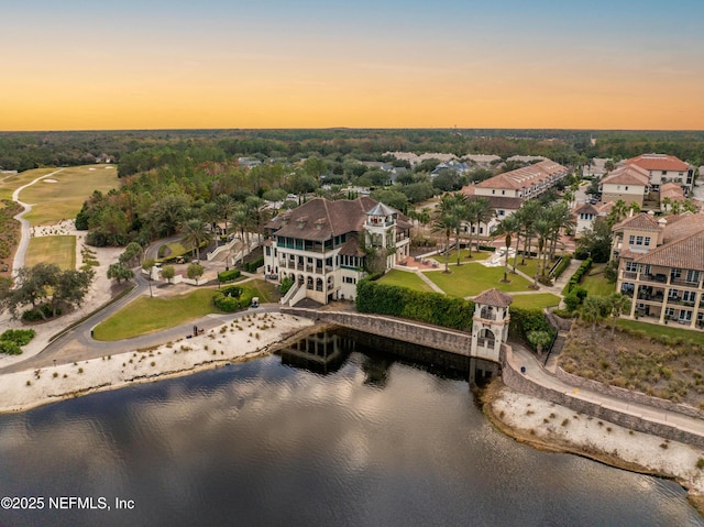 aerial view at dusk with a water view