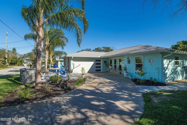 single story home with driveway and a garage