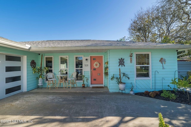 view of front facade with a garage and covered porch