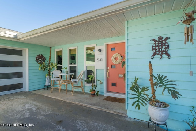 property entrance with covered porch