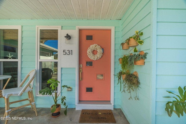 property entrance with a garage and covered porch