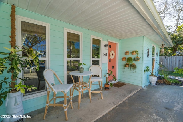 view of patio / terrace with a porch and fence