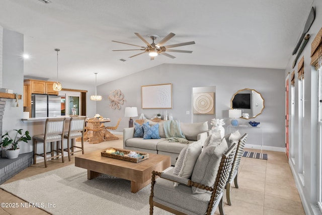 living room featuring light tile patterned floors, lofted ceiling, a ceiling fan, and baseboards