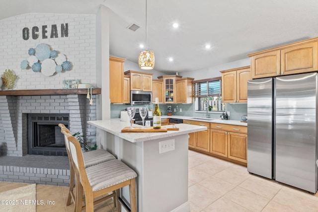 kitchen with stainless steel appliances, a peninsula, a sink, light countertops, and glass insert cabinets