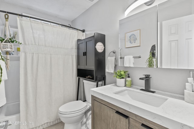 bathroom with toilet, shower / tub combo, and vanity