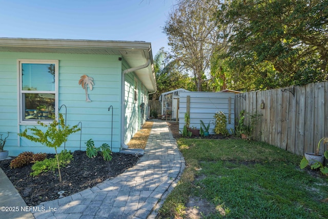 view of home's exterior featuring a lawn and a fenced backyard