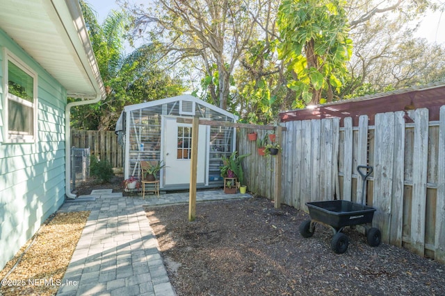 view of yard with an outdoor structure and a fenced backyard