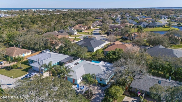 drone / aerial view featuring a water view and a residential view