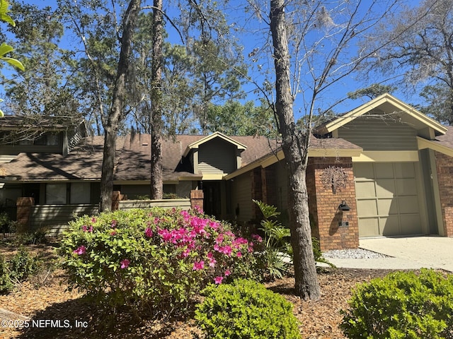 view of property exterior featuring brick siding and an attached garage