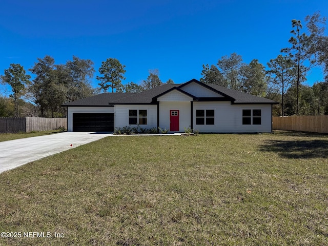 view of front of home with driveway, a front lawn, an attached garage, and fence