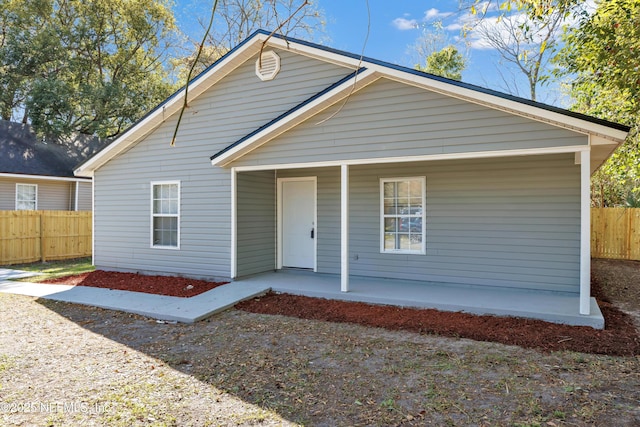 view of front facade featuring fence and a porch